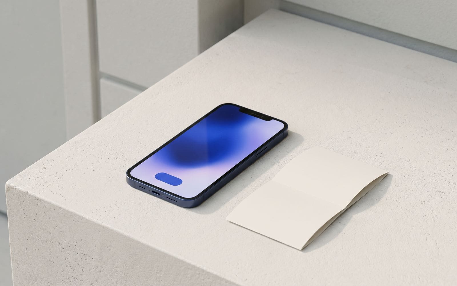 A smartphone on a desk showing a checkout screen with a single blue button, beside a folded receipt