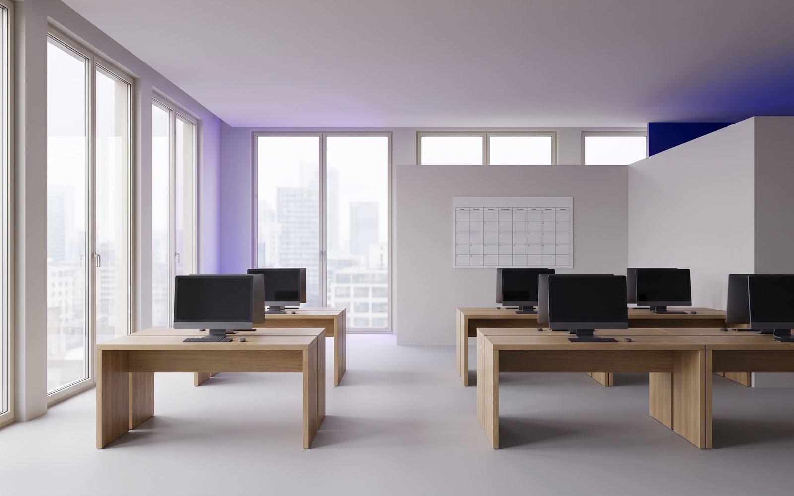 A small open-plan office with six desks in two rows and big windows